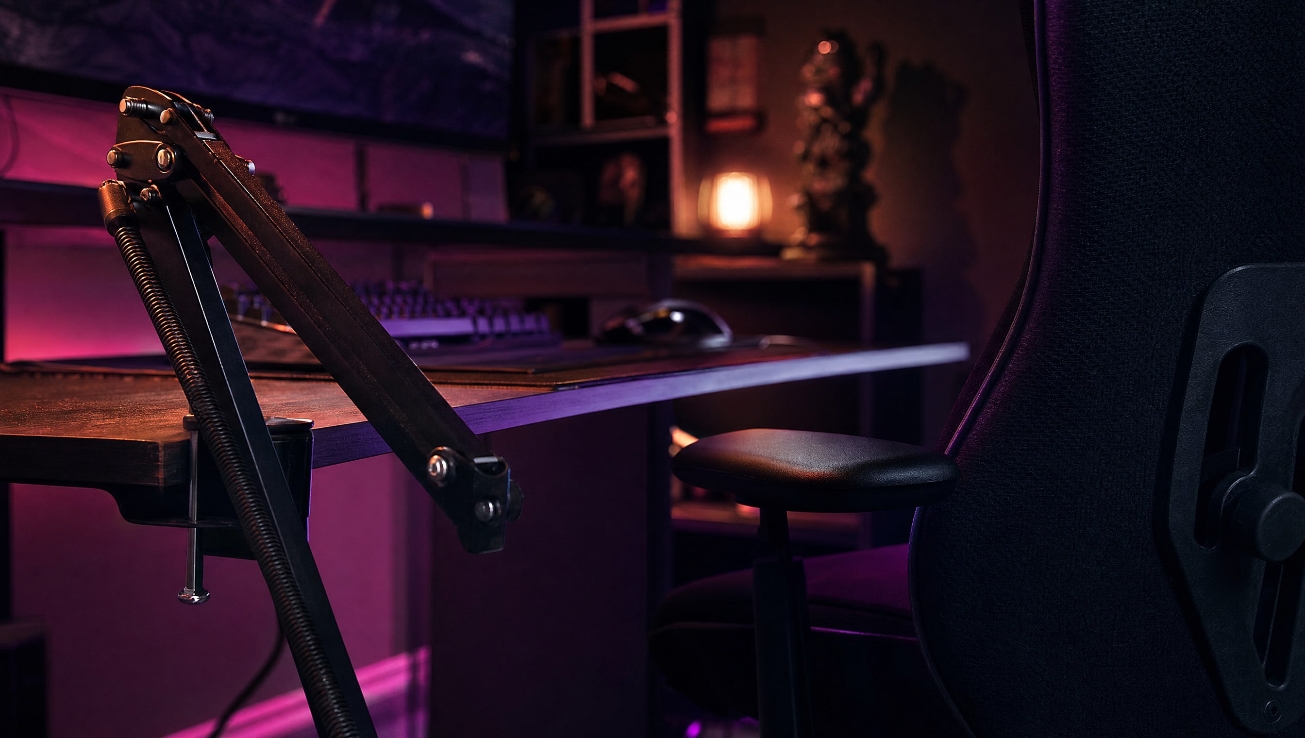 A boom arm folded back against a desk edge, its springs and clamp visible.