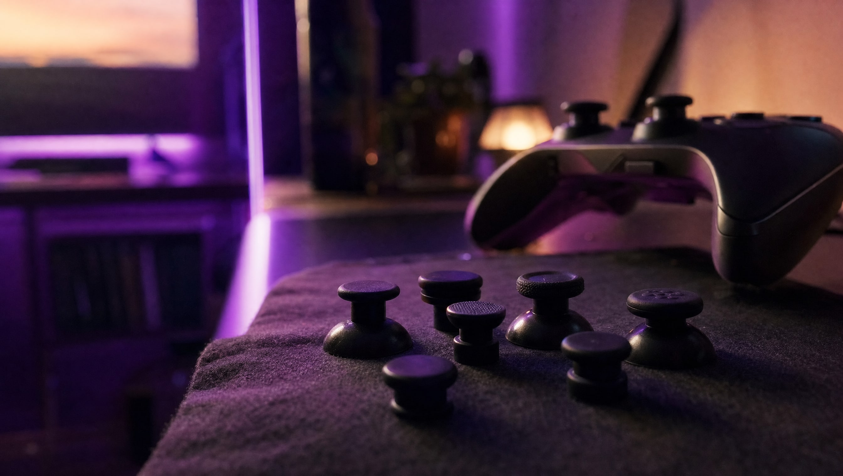 A set of thumbstick caps of different heights and shapes laid out on dark cloth.