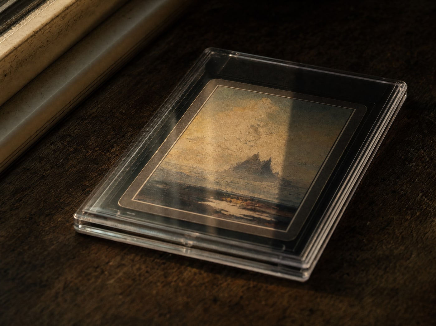 A slab lying face up under a window, one half in direct light and one half in shade, the difference visible in the plastic.